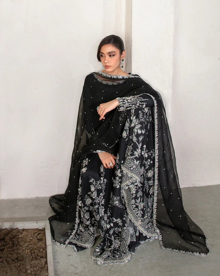 Model wearing a black Ciar dress from Faiza Saqlain's Lenora Luxury Pret '24 collection. Pakistani clothes online in UK.