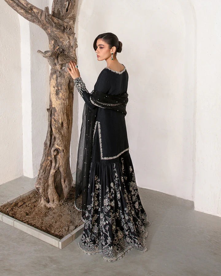 Model wearing a black Ciar dress from Faiza Saqlain's Lenora Luxury Pret '24 collection. Pakistani clothes online in UK.