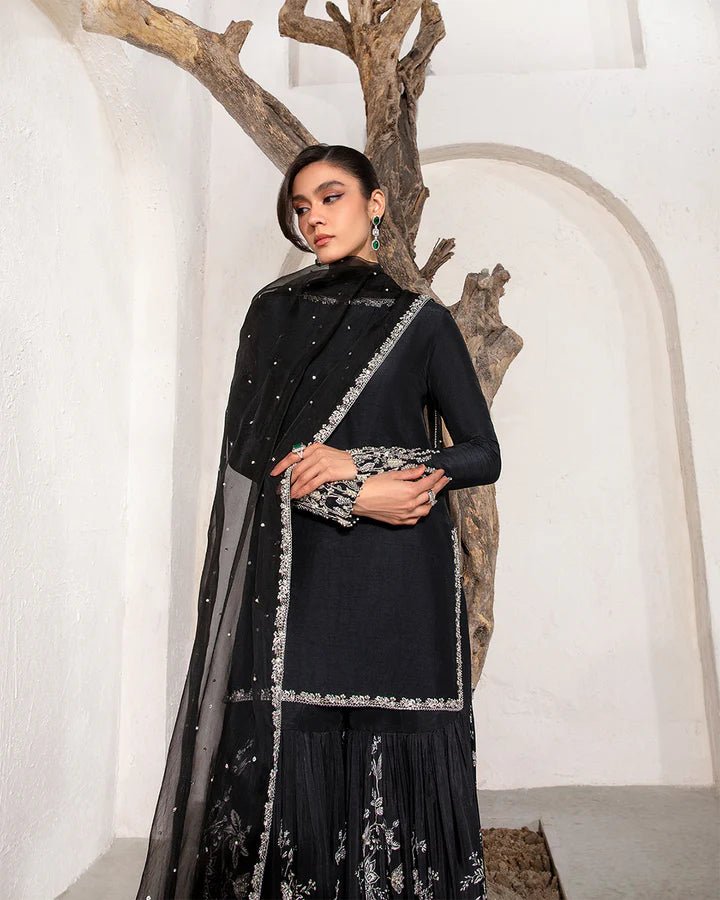 Model wearing a black Ciar dress from Faiza Saqlain's Lenora Luxury Pret '24 collection. Pakistani clothes online in UK.