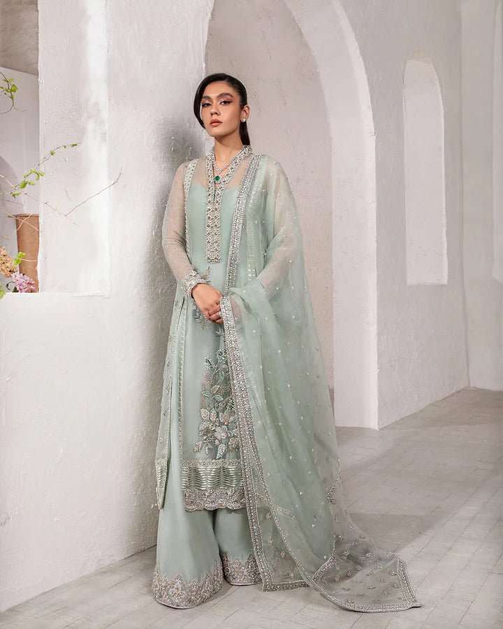 Model wearing a mint green Marvela dress from Faiza Saqlain's Lenora Luxury Pret '24 collection. Pakistani clothes online in UK.