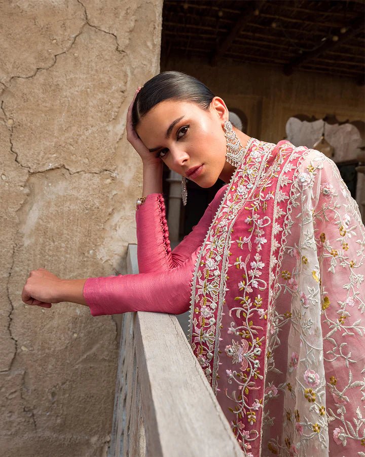 Model wearing a vibrant pink Hafa dress from Faiza Saqlain's Luxe Formals Laira collection, highlighting elegant Pakistani attire available online in the UK.