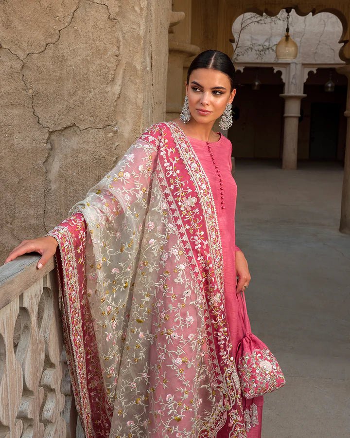 Model wearing a vibrant pink Hafa dress from Faiza Saqlain's Luxe Formals Laira collection, highlighting elegant Pakistani attire available online in the UK.