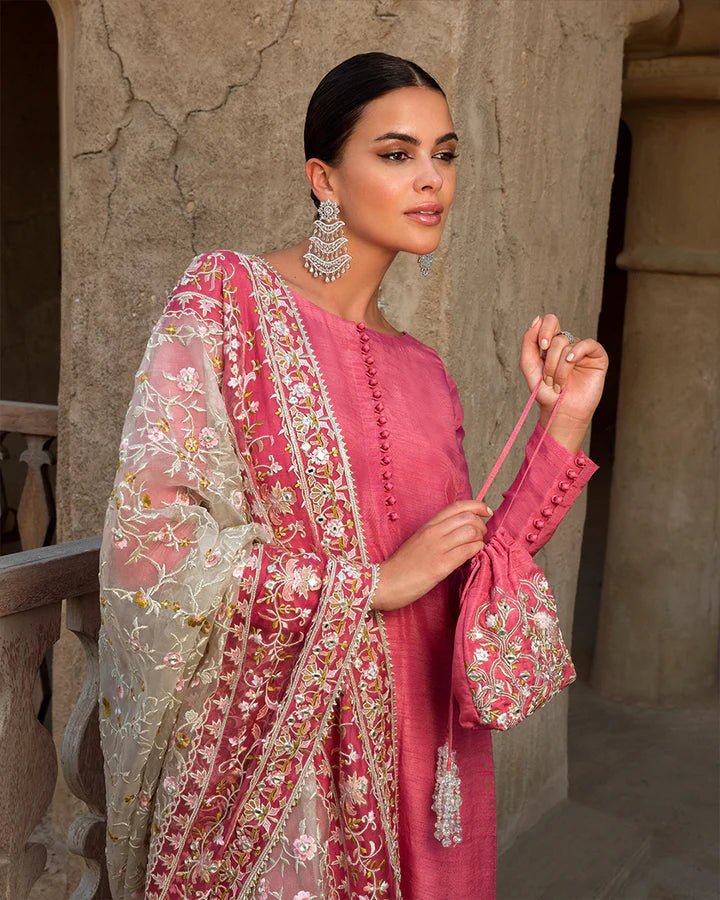 Model wearing a vibrant pink Hafa dress from Faiza Saqlain's Luxe Formals Laira collection, highlighting elegant Pakistani attire available online in the UK.