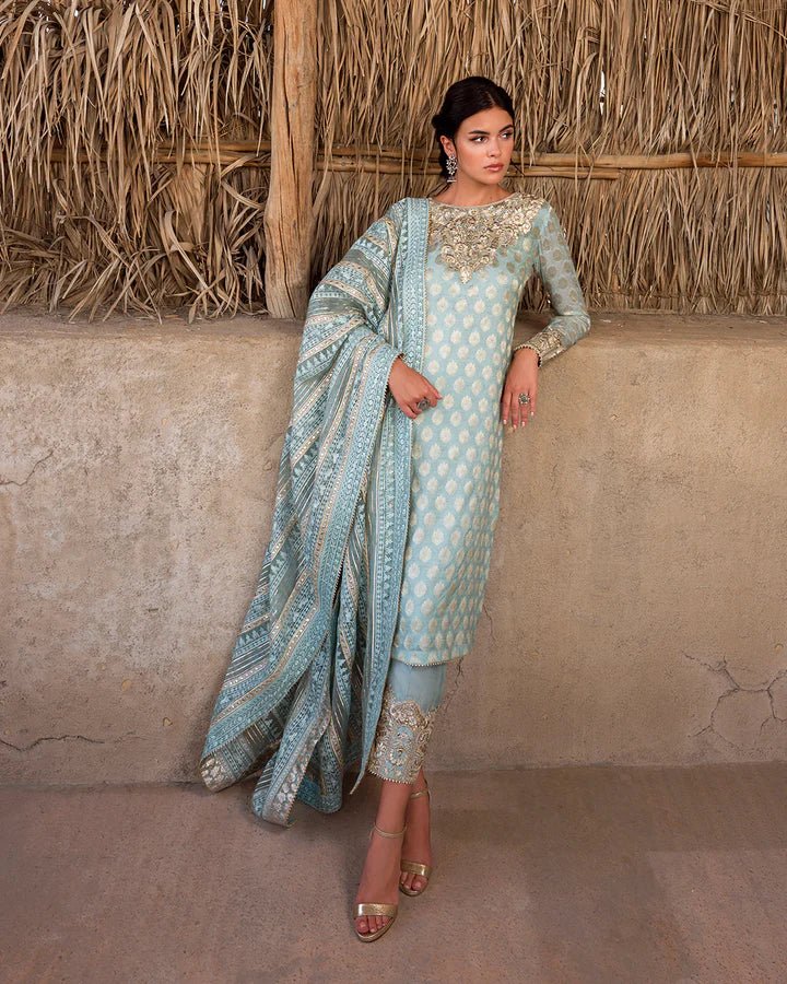 Model wearing a serene aqua Saahi dress by Faiza Saqlain, representing stylish Pakistani attire online in the UK.