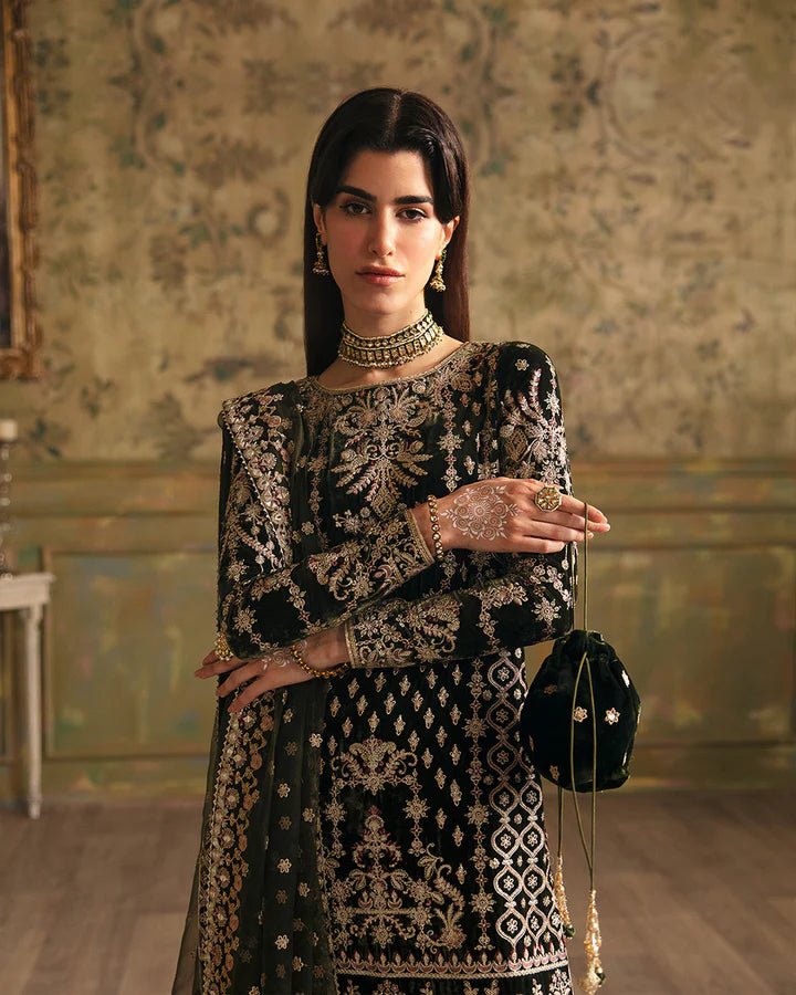 Model wearing a black Adara dress with gold embroidery from Faiza Saqlain's Luxe Formals Manaar Nov '23 collection. Pakistani clothes online in UK.