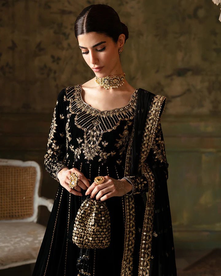 Model wearing a black Venera dress with gold embellishments from Faiza Saqlain's Luxe Formals Manaar Nov '23 collection. Pakistani clothes online in UK.