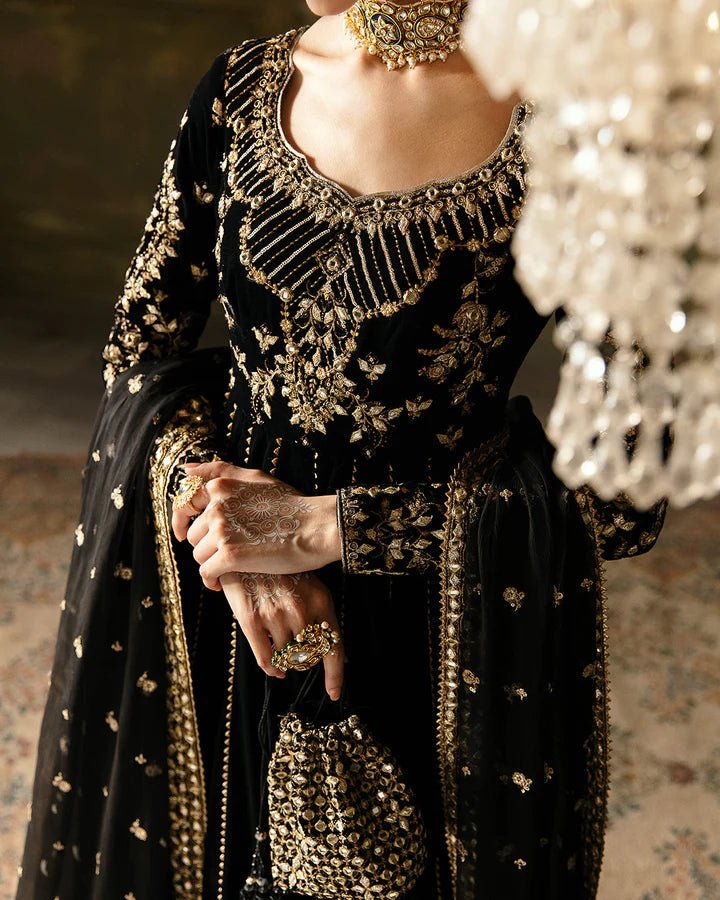 Model wearing a black Venera dress with gold embellishments from Faiza Saqlain's Luxe Formals Manaar Nov '23 collection. Pakistani clothes online in UK.