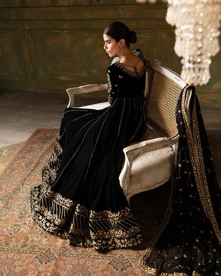 Model wearing a black Venera dress with gold embellishments from Faiza Saqlain's Luxe Formals Manaar Nov '23 collection. Pakistani clothes online in UK.