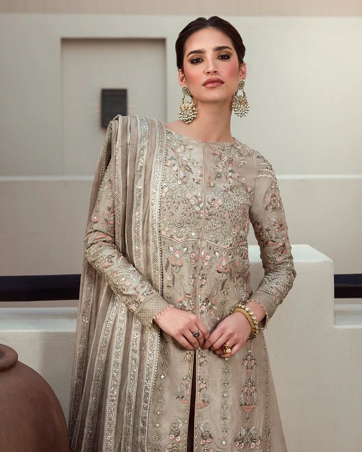 Model wearing a beige Arsh dress with intricate embroidery from Faiza Saqlain's Aleira Evening Edit '24 collection. Pakistani clothes online in UK.