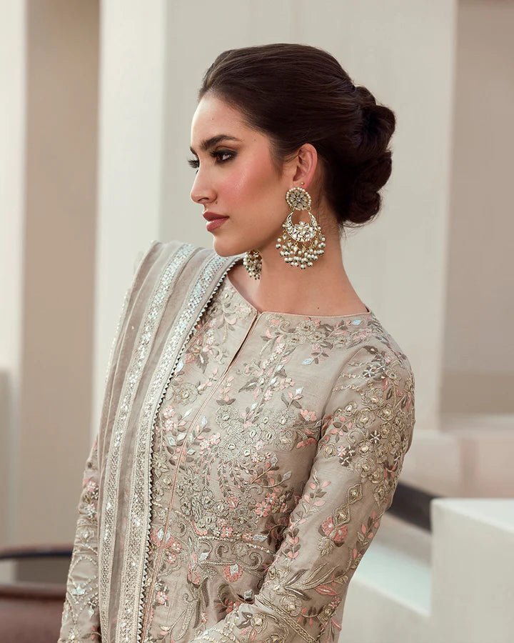 Model wearing a beige Arsh dress with intricate embroidery from Faiza Saqlain's Aleira Evening Edit '24 collection. Pakistani clothes online in UK.