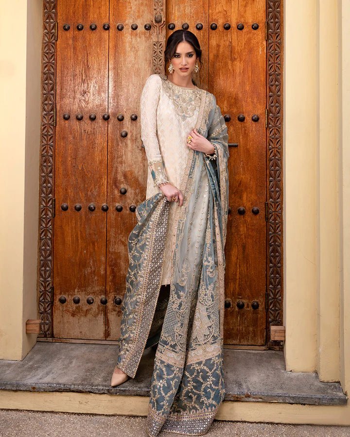 Model in Faiza Saqlain UK Talia, intricate Pakistani clothes UK, Noor e Chashm Feb '23, by ornate door.