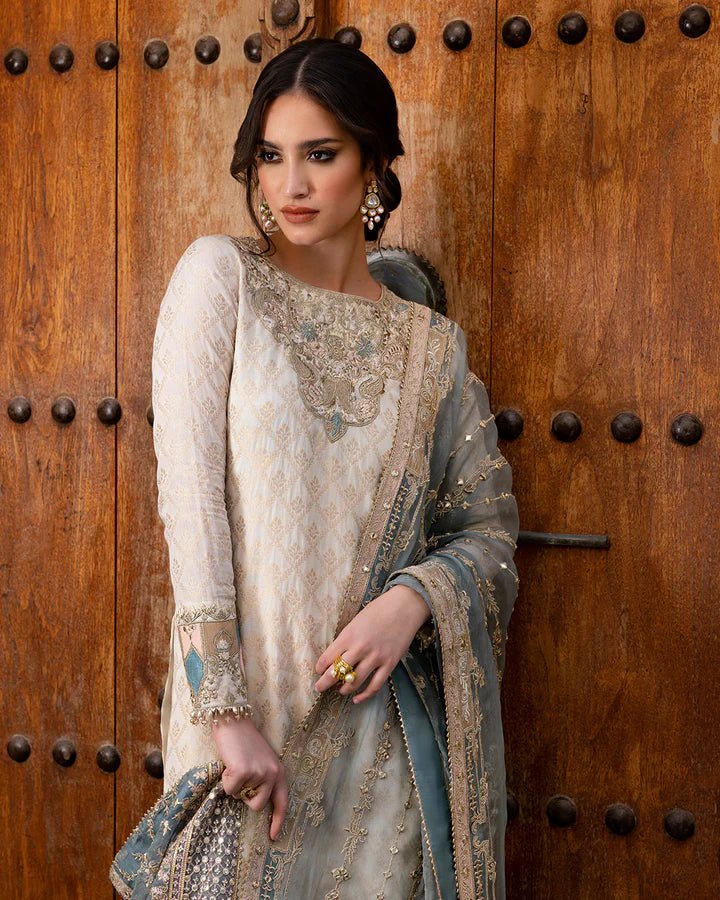 Model wearing a pale blue Talia dress from Faiza Saqlain's Luxe Formals Noor e Chashm collection, showcasing elegant Pakistani clothes online in the UK.