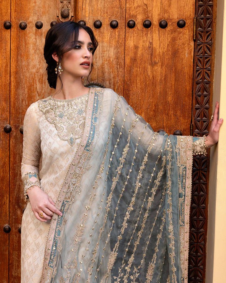 Model wearing a pale blue Talia dress from Faiza Saqlain's Luxe Formals Noor e Chashm collection, showcasing elegant Pakistani clothes online in the UK.