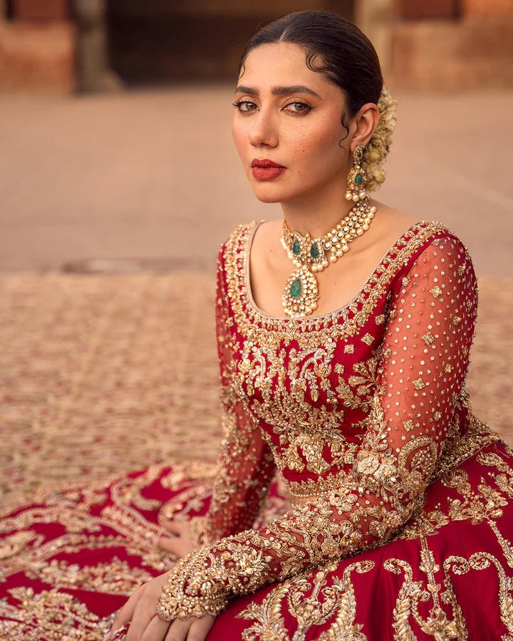 Model wearing a red Arusa bridal dress from Faiza Saqlain, intricately embroidered with gold detailing. Perfect for luxury bridal wear, available online in the UK.