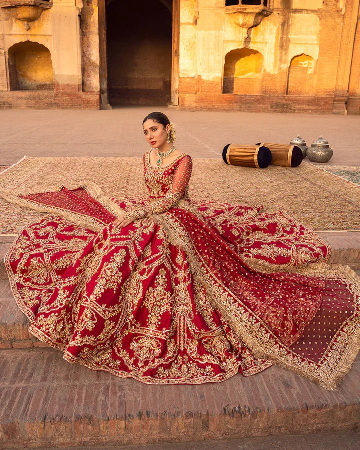 Model wearing a red Arusa bridal dress from Faiza Saqlain, intricately embroidered with gold detailing. Perfect for luxury bridal wear, available online in the UK.