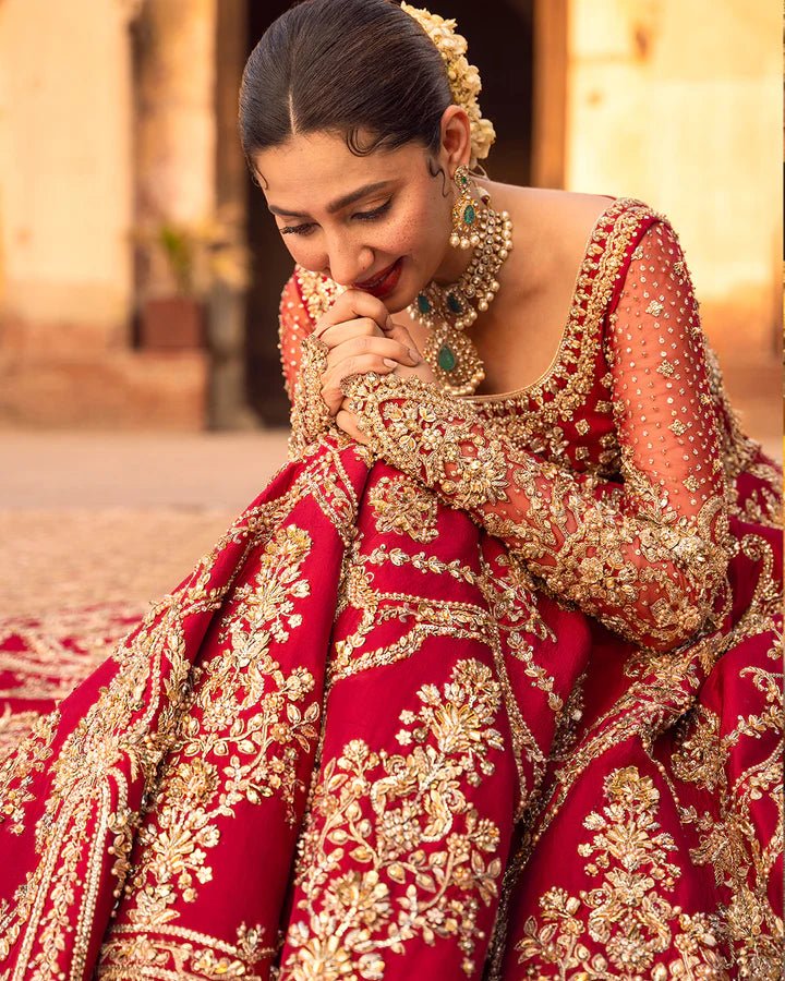 Model wearing a red Arusa bridal dress from Faiza Saqlain, intricately embroidered with gold detailing. Perfect for luxury bridal wear, available online in the UK.