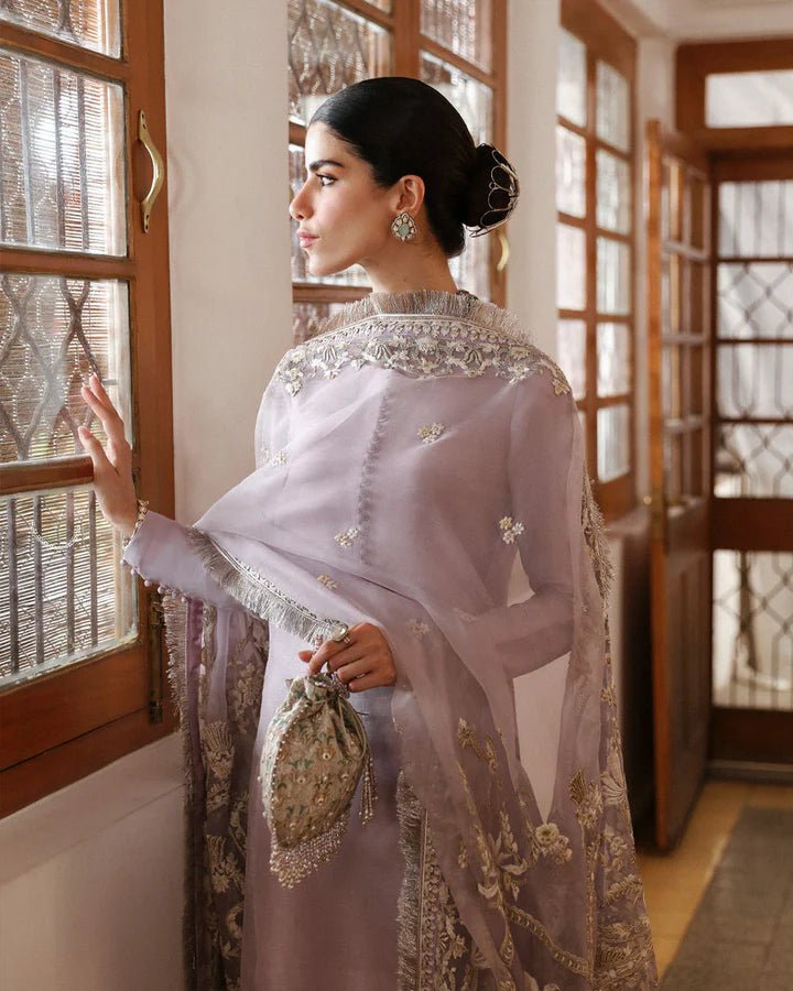 Model wearing a maroon dress with intricate silver embroidery from Faiza Saqlain's Mehermah Luxe Formals '24 collection, perfect for weddings.