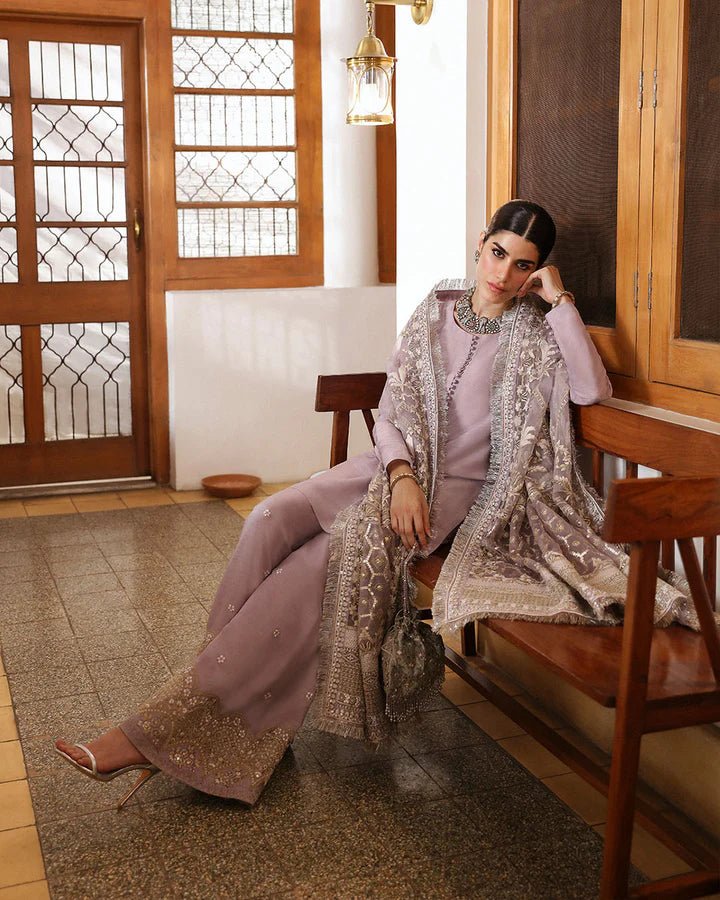 Model wearing a maroon dress with intricate silver embroidery from Faiza Saqlain's Mehermah Luxe Formals '24 collection, perfect for weddings.