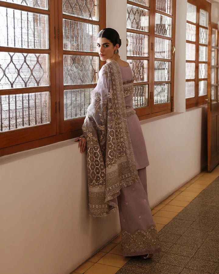 Model wearing a maroon dress with intricate silver embroidery from Faiza Saqlain's Mehermah Luxe Formals '24 collection, perfect for weddings.