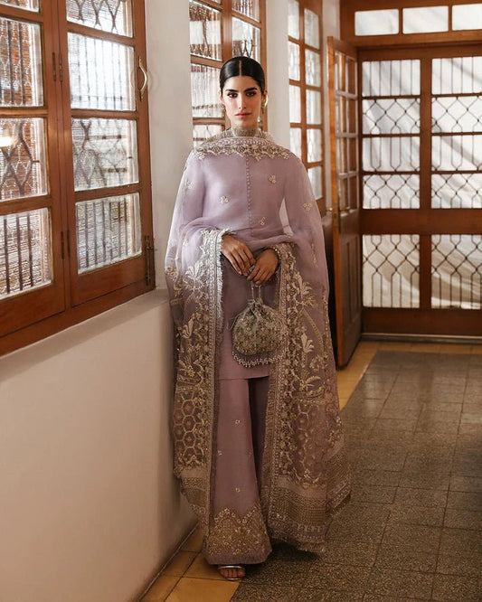 Model wearing a maroon dress with intricate silver embroidery from Faiza Saqlain's Mehermah Luxe Formals '24 collection, perfect for weddings.