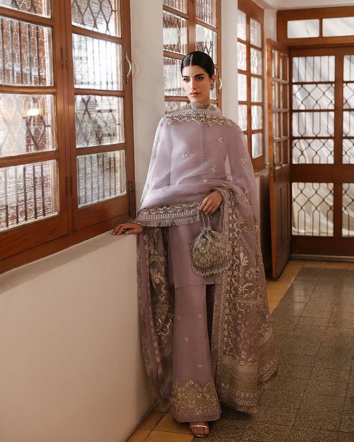 Model wearing a maroon dress with intricate silver embroidery from Faiza Saqlain's Mehermah Luxe Formals '24 collection, perfect for weddings.