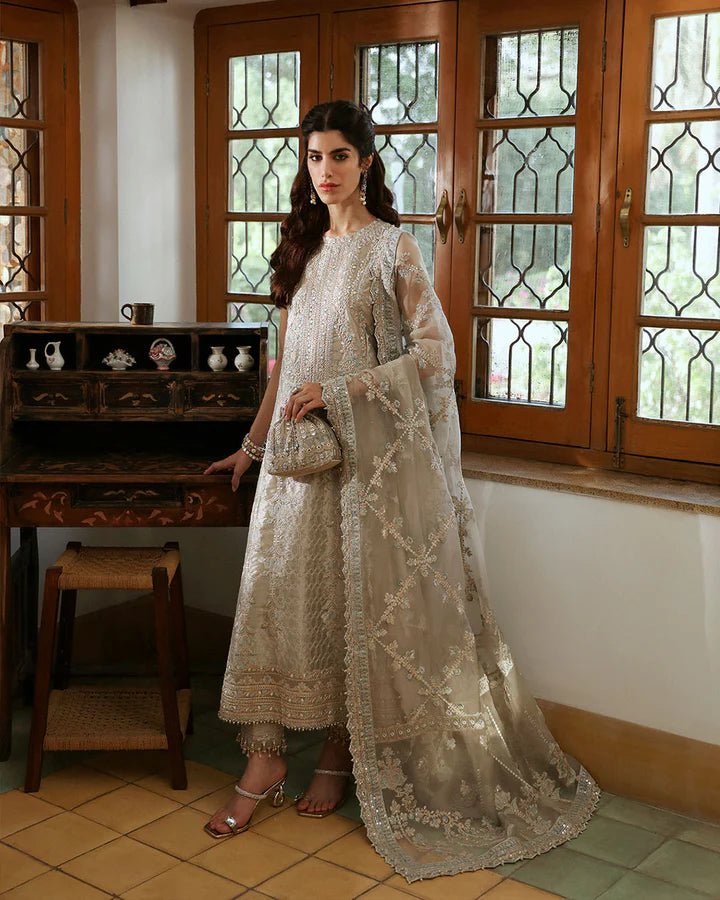 Model wearing maroon Norine dress from Faiza Saqlain's Mehermah Luxe Formals '24, showcasing Pakistani wedding clothes available online in the UK.