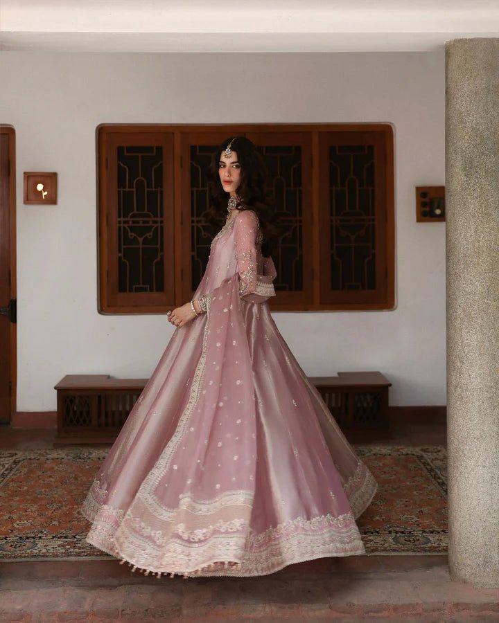 Model wearing a dusty rose Halina dress from Faiza Saqlain's Mehermah Luxe Formals '24. Perfect for Pakistani wedding clothes online in UK.