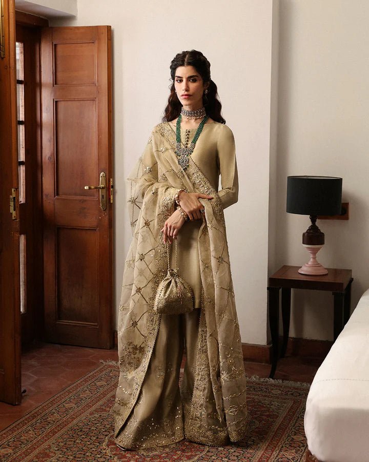 Model wearing a maroon Norine dress from Faiza Saqlain's Mehermah Luxe Formals '24. Highlighting Faiza Saqlain, Pakistani clothes online in UK, and wedding clothes.