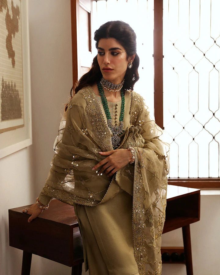 Model wearing a maroon Norine dress from Faiza Saqlain's Mehermah Luxe Formals '24. Highlighting Faiza Saqlain, Pakistani clothes online in UK, and wedding clothes.