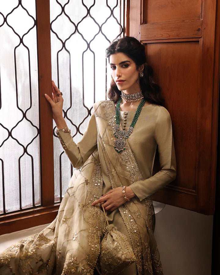 Model wearing a maroon Norine dress from Faiza Saqlain's Mehermah Luxe Formals '24. Highlighting Faiza Saqlain, Pakistani clothes online in UK, and wedding clothes.