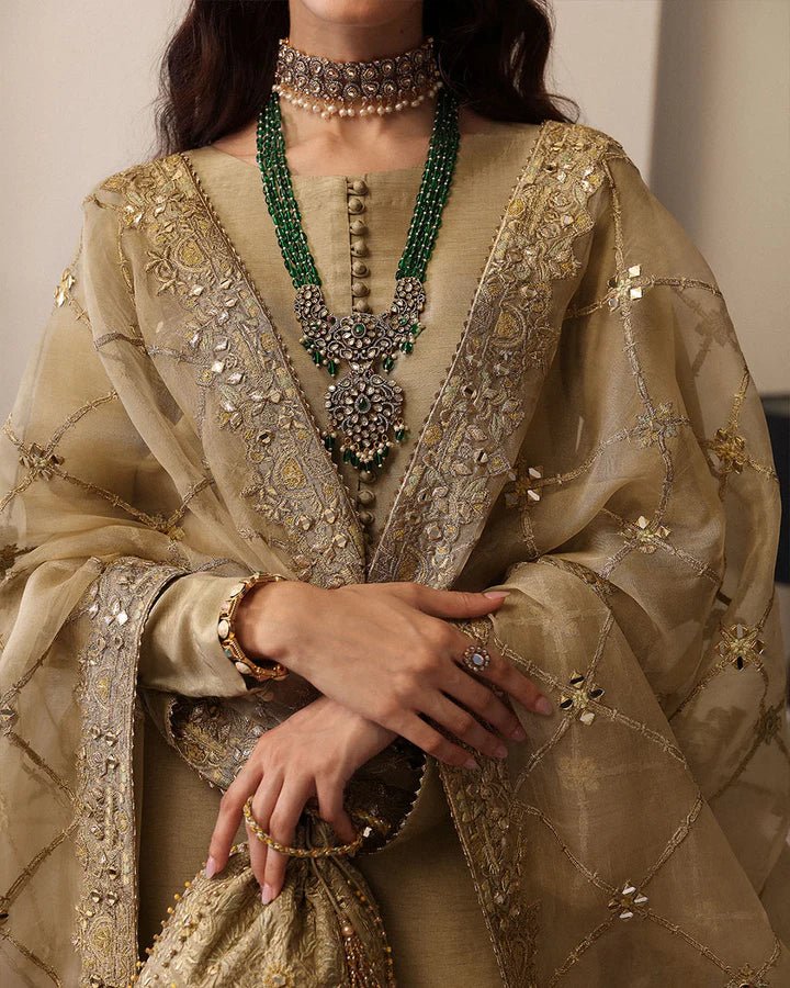 Model wearing a maroon Norine dress from Faiza Saqlain's Mehermah Luxe Formals '24. Highlighting Faiza Saqlain, Pakistani clothes online in UK, and wedding clothes.