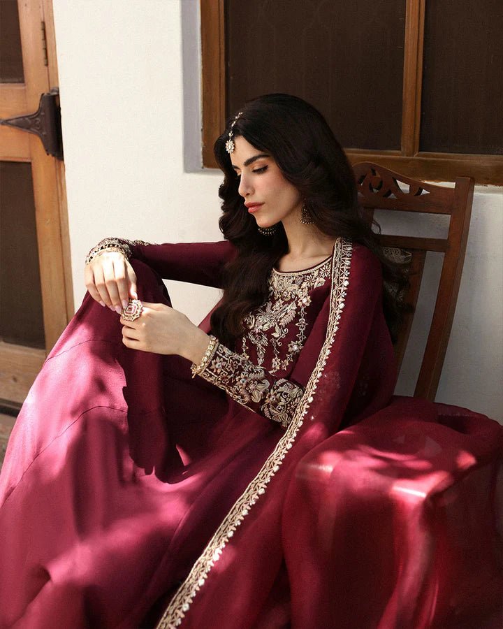 Model wearing a maroon dress with intricate gold embroidery, from Faiza Saqlain's Mehermah Luxe Formals '24 collection, highlighting Pakistani clothes online in UK and wedding clothes.