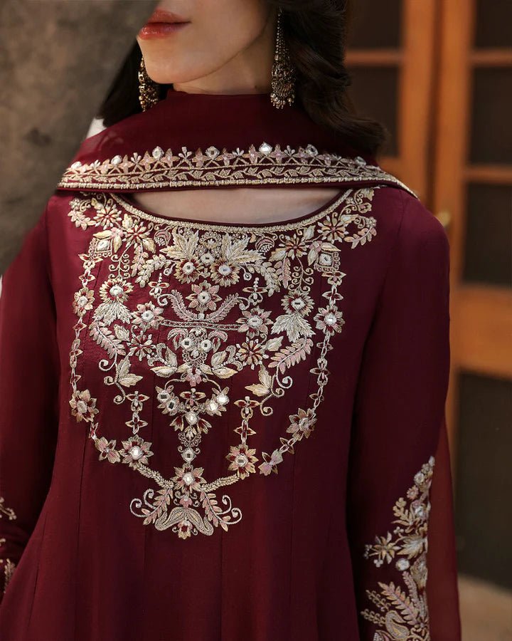 Model wearing a maroon dress with intricate gold embroidery, from Faiza Saqlain's Mehermah Luxe Formals '24 collection, highlighting Pakistani clothes online in UK and wedding clothes.