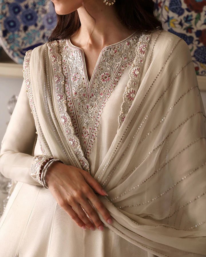 Model wearing Sabina cream dress from Faiza Saqlain, showcasing intricate embroidery and luxurious detailing, ideal for wedding attire. Pakistani clothes online in UK.