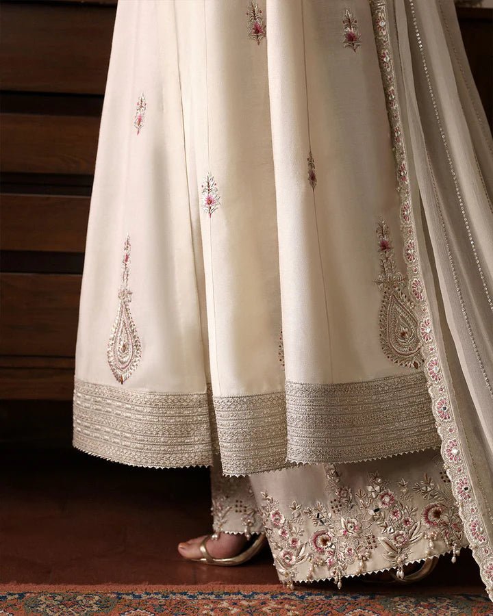 Model wearing Sabina cream dress from Faiza Saqlain, showcasing intricate embroidery and luxurious detailing, ideal for wedding attire. Pakistani clothes online in UK.