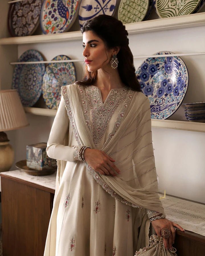 Model wearing Sabina cream dress from Faiza Saqlain, showcasing intricate embroidery and luxurious detailing, ideal for wedding attire. Pakistani clothes online in UK.