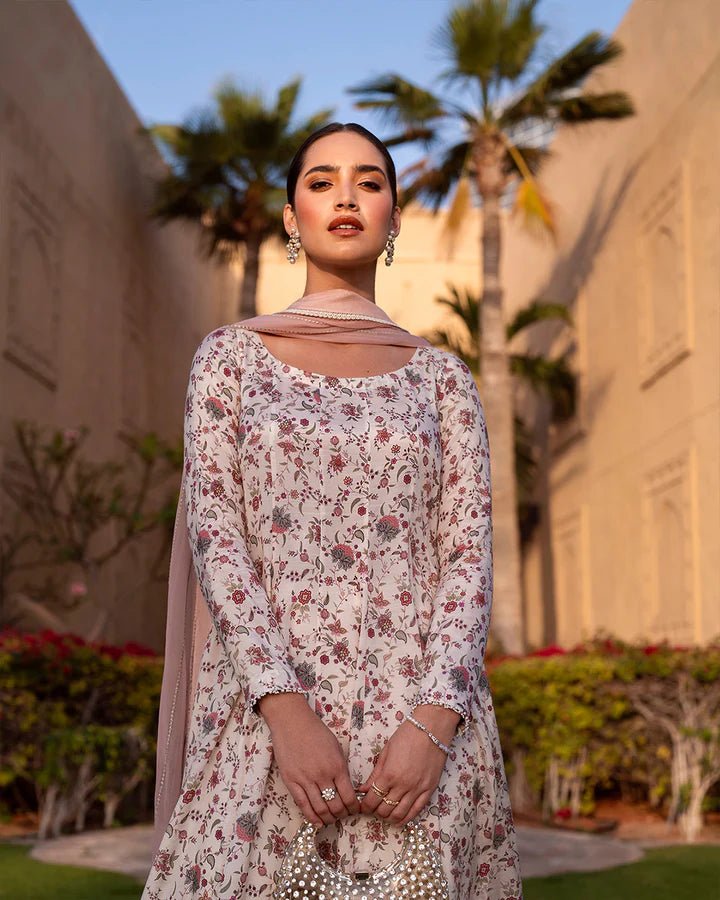 Model wearing cream floral Elysia dress from Faiza Saqlain's Zurina Luxe Silk Edit '24 collection. Pakistani clothes online in UK.