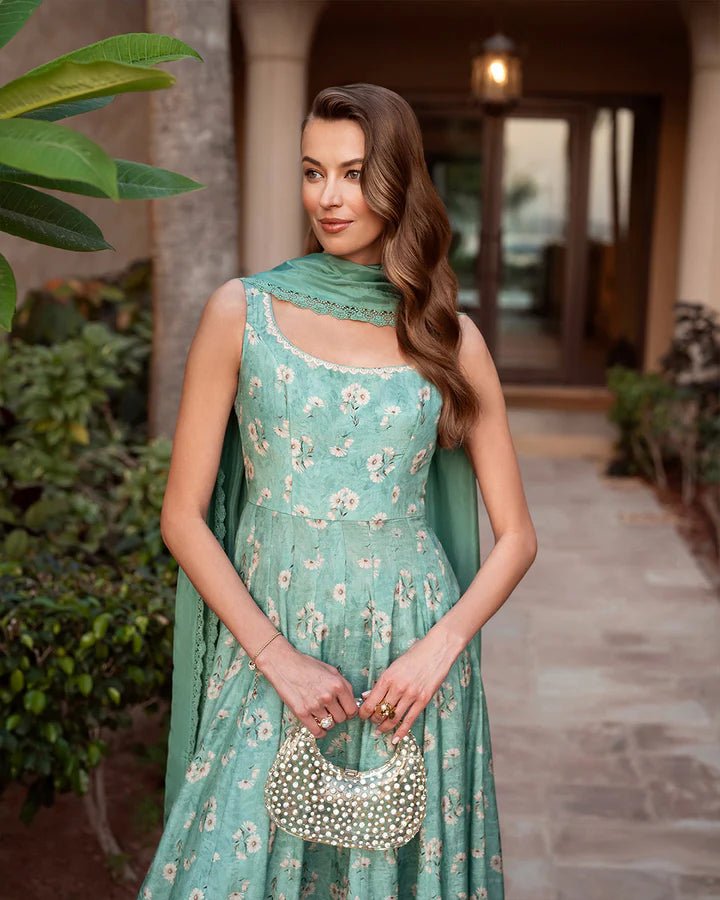 Model wearing turquoise floral Felisa dress from Faiza Saqlain's Zurina Luxe Silk Edit '24 collection. Pakistani clothes online in UK.