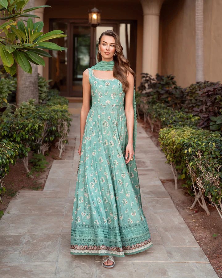 Model wearing the Felisa dress from Faiza Saqlain’s Zurina Luxe Silk Edit 2024, in sea - green with subtle floral patterns. Pakistani designer clothes available in the UK. Ideal for Eid dresses.