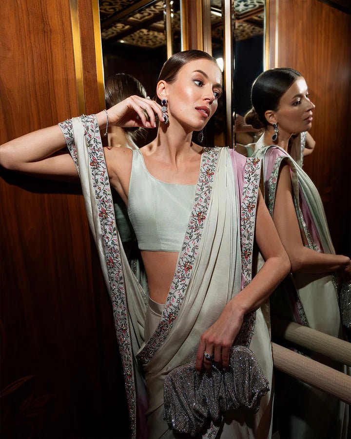 Model wearing an elegant pastel Lenci saree with floral embroidery from Faiza Saqlain's Zurina Luxe Silk Edit '24 collection. Pakistani clothes online in UK.