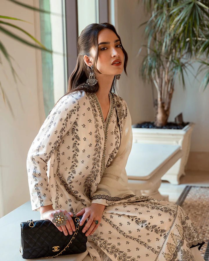 Model wearing white Mireya dress with intricate black embroidery from Faiza Saqlain's Zurina Luxe Silk Edit '24 collection. Pakistani clothes online in UK.