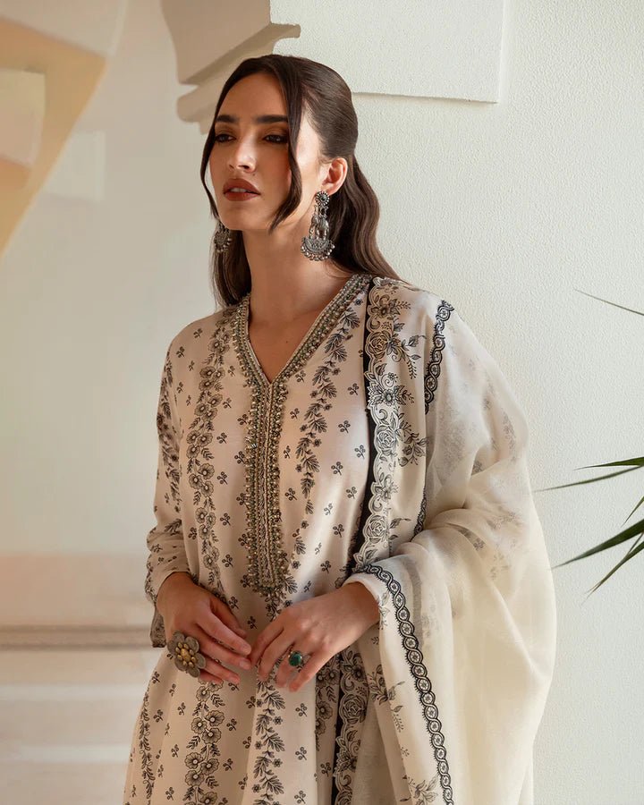 Model wearing white Mireya dress with intricate black embroidery from Faiza Saqlain's Zurina Luxe Silk Edit '24 collection. Pakistani clothes online in UK.