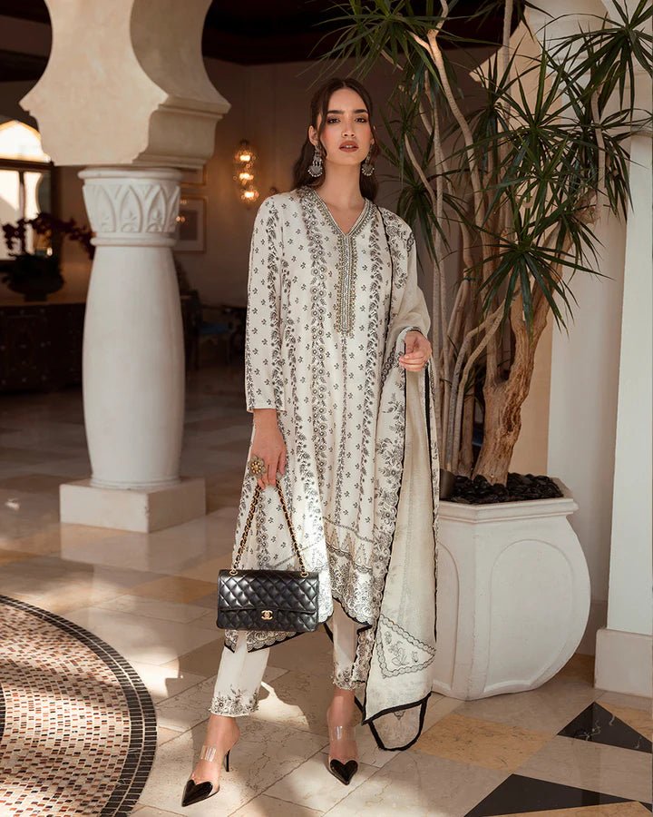 Model wearing the Mireya dress from Faiza Saqlain’s Zurina Luxe Silk Edit 2024, in off - white with intricate embroidery. Pakistani designer clothes available in the UK. Ideal for Eid dresses.