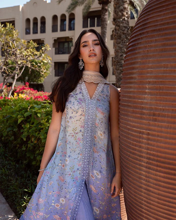 Model wearing blue floral Sybilla dress from Faiza Saqlain's Zurina Luxe Silk Edit '24 collection. Pakistani clothes online in UK.