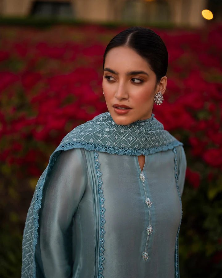 Model wearing a blue Venilia dress with intricate patterns from Faiza Saqlain's Zurina Luxe Silk Edit '24 collection. Pakistani clothes online in UK.