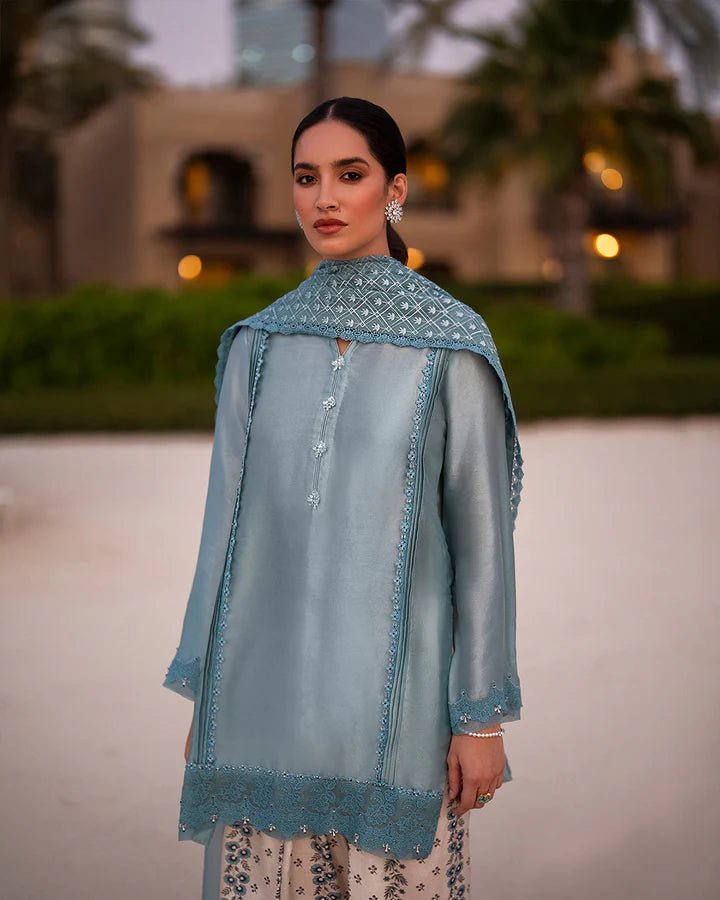 Model wearing a blue Venilia dress with intricate patterns from Faiza Saqlain's Zurina Luxe Silk Edit '24 collection. Pakistani clothes online in UK.