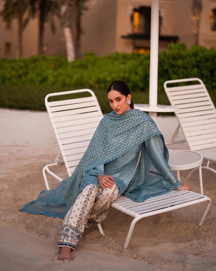 Model wearing a blue Venilia dress with intricate patterns from Faiza Saqlain's Zurina Luxe Silk Edit '24 collection. Pakistani clothes online in UK.