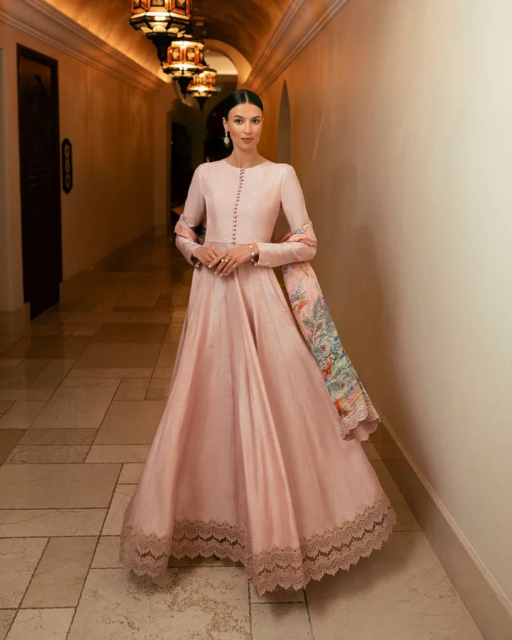 Model wearing a pink Zelina dress with intricate lace details from Faiza Saqlain's Zurina Luxe Silk Edit '24 collection. Pakistani clothes online in UK.