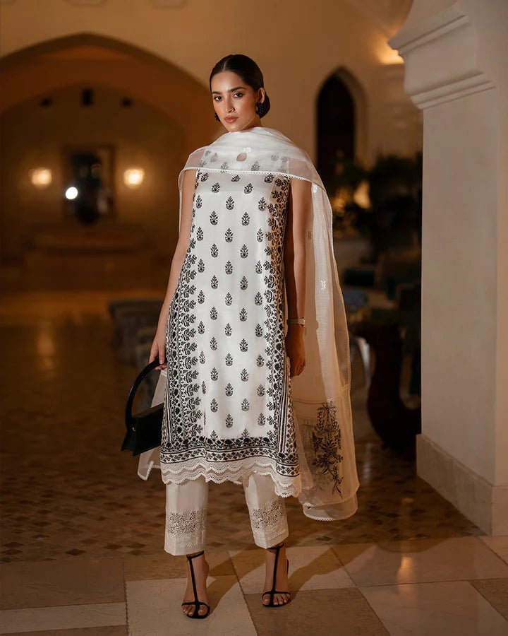 Model wearing the Zita dress from Faiza Saqlain Zurina Luxe Silk Edit '24 in white with black embroidery, ideal for Pakistani designer Eid dresses in the UK.