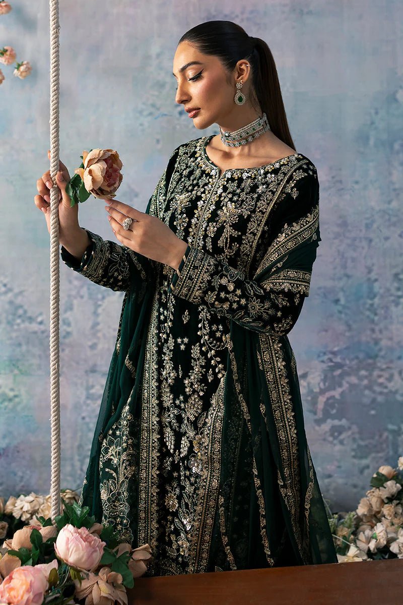 Model wearing Eden from Gulaal's Celeste Unstitched Velvet '24 collection in deep green. Luxury pret, festive, Pakistani clothes online in UK.